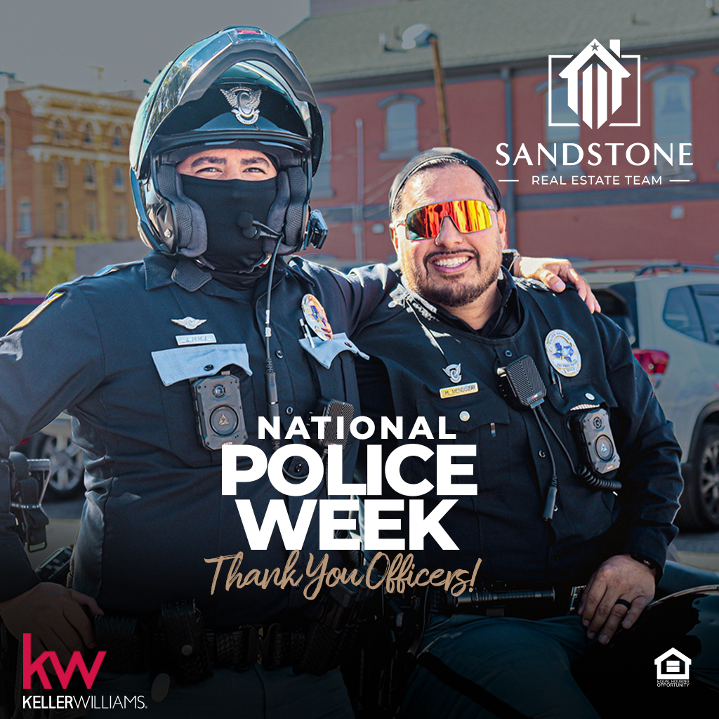 Two police men posing for National Police Week 2026 with Sandstone Real Estate Team branding